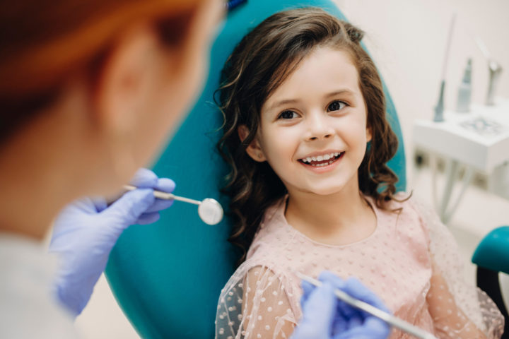 young girl smiling at her hygienist - Yukon Kids Dental