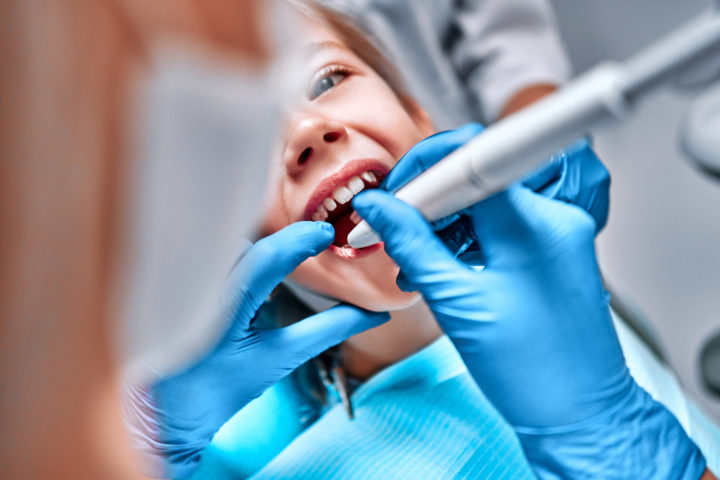 child getting teeth cleaned - Yukon Kids Dental